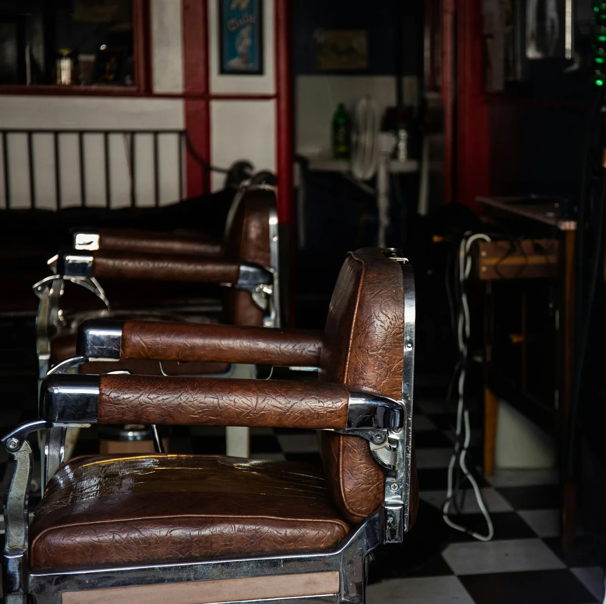 Empty brown leather barber chairs in a generic shop interior, not Kim's Family Haircut